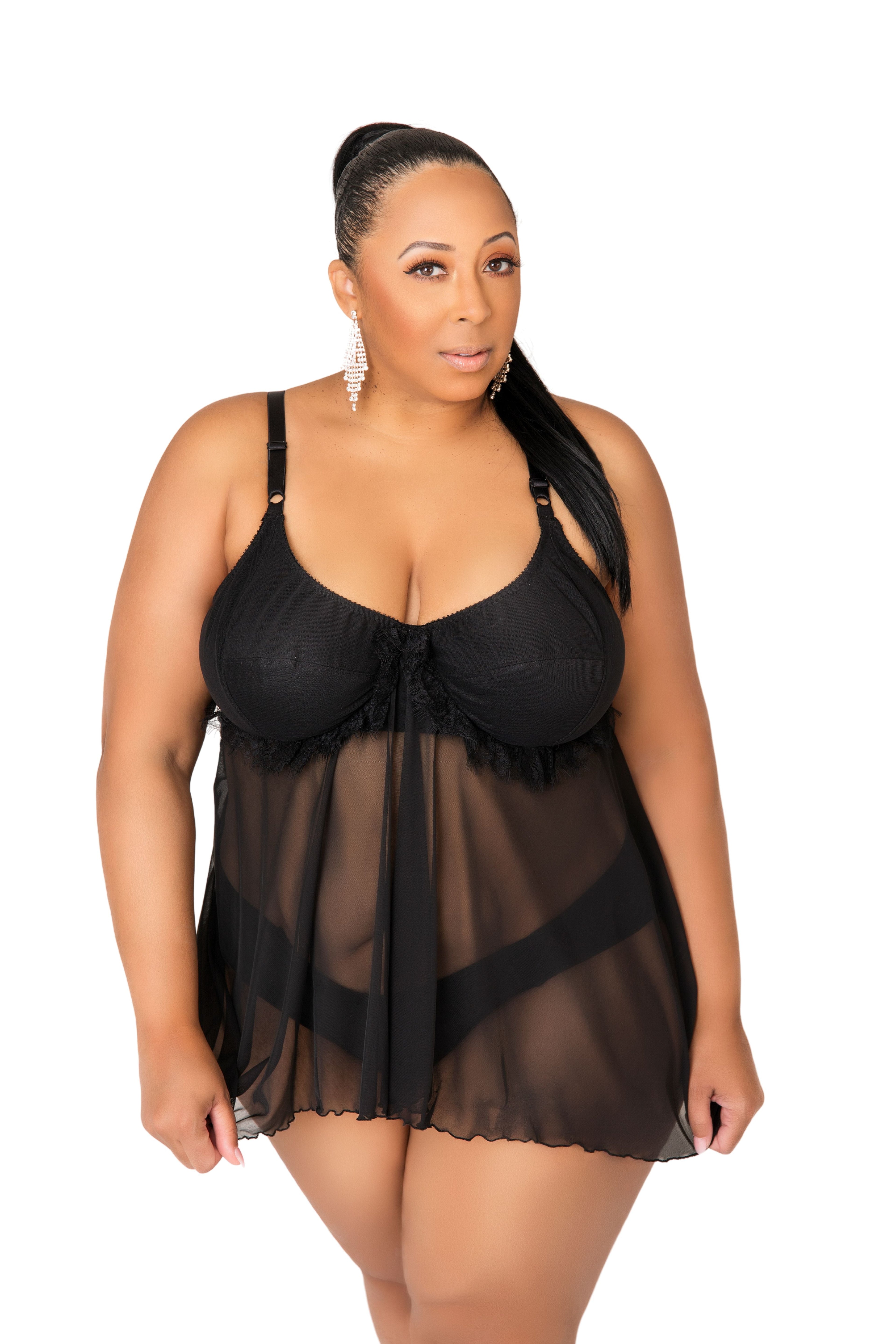 Woman wearing a black lace lingerie set on a white background