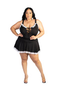Woman wearing a black nightgown with white lace trim on a white background